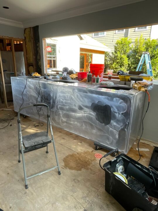 Before: a long acrylic aquarium clouded with heavy scratching.