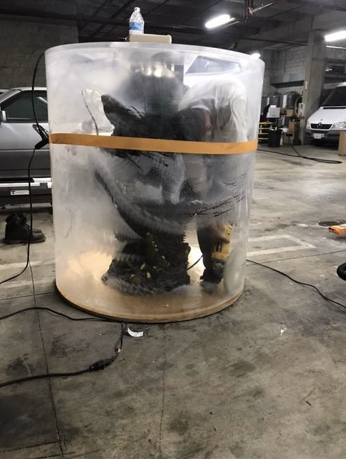 Before: a cylindrical acrylic tank heavily clouded, with its rock column still inside.